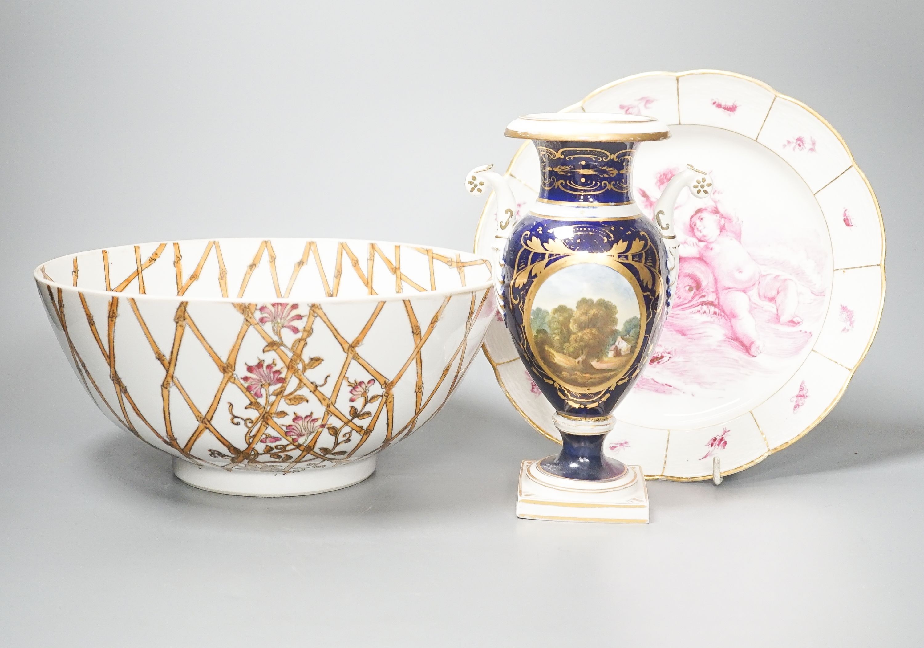 A Furstenburg dessert plate, later painted in puce, signed in reverse ‘W Munscher Stuttgart 1875’, 14.75cm an early 19th century Derby vase and a chinoiserie porcelain bowl (3)